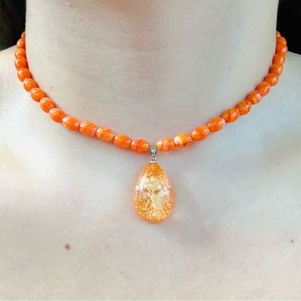 Orange and white beaded necklace with a touch of glamour